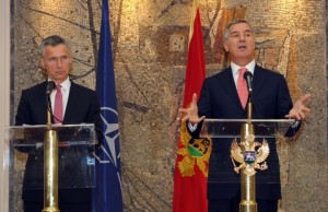 Montenegro's Prime Minister Milo Djukanovic, right, speaks and gestures after talks with NATO Secretary-General Jens Stoltenberg, in Podgorica, Montenegro, Thursday, June 11, 2015. Montenegro will have to beef up its public support for NATO and strengthen the rule of law before it can become a member, the alliance's secretary-general said Thursday. (AP Photo/Risto Bozovic)