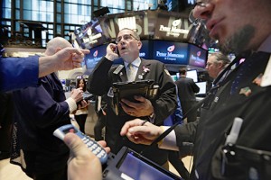 Traders work on the floor of the New York Stock Exchange, Friday, March 20, 2015. Stocks were moving higher Friday as oil prices recovered from their decline the previous day. Strong earnings from restaurant chain Darden and Nike also helped lift the market. (AP Photo/Richard Drew)