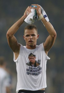 Locomotiv Moscow's Dmitri Tarasov features an inner shirt with a picture of Russian President Vladimir Putin and the slogan "The most polite President",  following a Europa League first leg round of 32, soccer match against Fenerbahce in Istanbul, Tuesday, Feb. 16, 2016. Fenerbahce won the match 2-0. (AP Photo/Emrah Gurel)