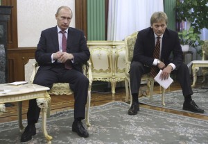 Russian Prime Minister Vladimir Putin, left, and  his spokesman Dmitry Peskov, seen during a teleconference with Turkish Prime Minister Recep Tayyip Erdogan while meeting  Italian Prime Minister Silvio Berlusconi, unseen in the photo, to discuss energy in St. Petersburg, Russia, Thursday, Oct. 22, 2009. Berlusconi has arrived in Russia for two days of talks with Putin. (AP Photo/RIA-Novosti, Alexei Nikolsky, Pool)