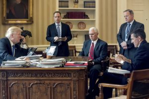 President Donald Trump accompanied by, from second from left, Chief of Staff Reince Priebus, Vice President Mike Pence, White House press secretary Sean Spicer and National Security Adviser Michael Flynn speaks on the phone with Russian President Vladimir Putin, Saturday, Jan. 28, 2017, in the Oval Office at the White House in Washington. (AP Photo/Andrew Harnik)